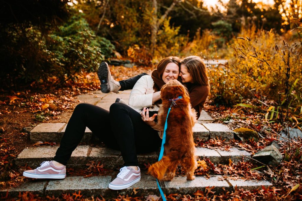 Photo of a couple playing with their dog during their in Massachusetts