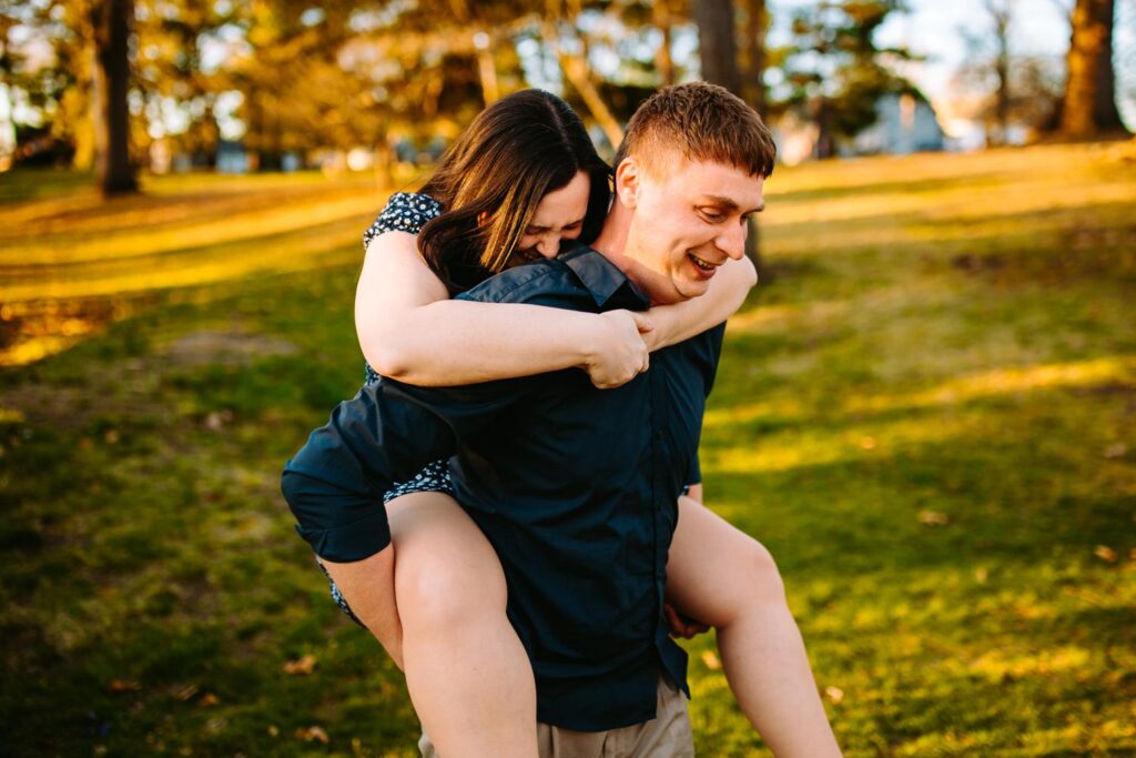 couple giving piggy back ride at Roger Williams Park in Providence, Rhode Island