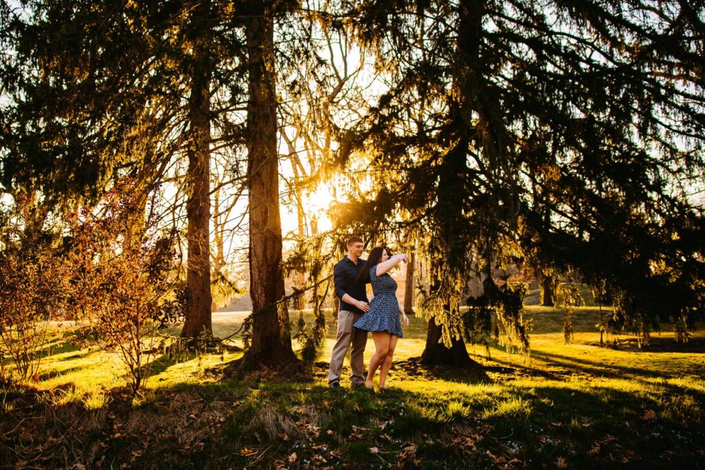 couple dancing under pine trees at Roger Williams Park in Providence, Rhode Island