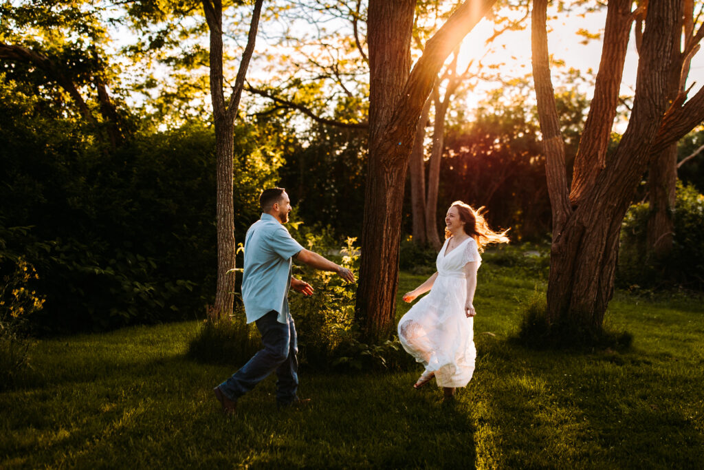 A couple runs towards eachother at their engagement session at Brenton Point State Park in Newport, Rhode Island