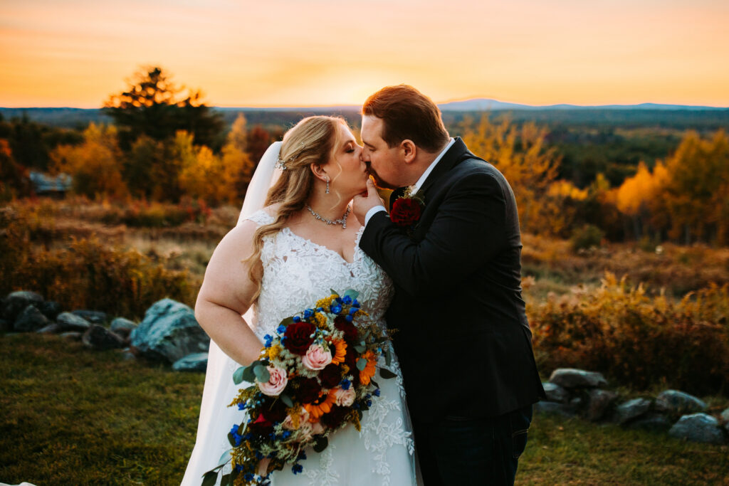 Bride and groom kiss at sunset at Fruitlands Museum Wedding in Harvard, Massachusetts