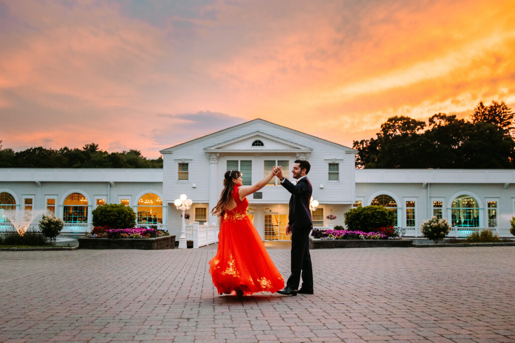 A bride and groom dance during sunset in front of the Aqua Turf Club at their wedding