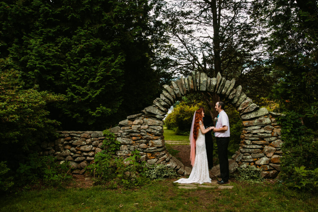 A micro-wedding ceremony at the circle arch at Kinney Azalea Garden in Rhode Island