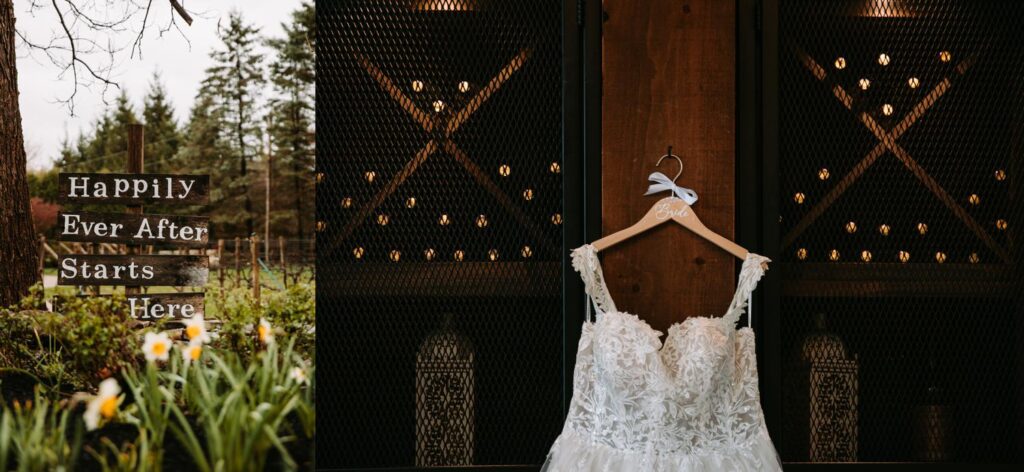 Hanging wedding dress with 'Happily Ever After Starts Here' sign at Birch Wood Vineyards