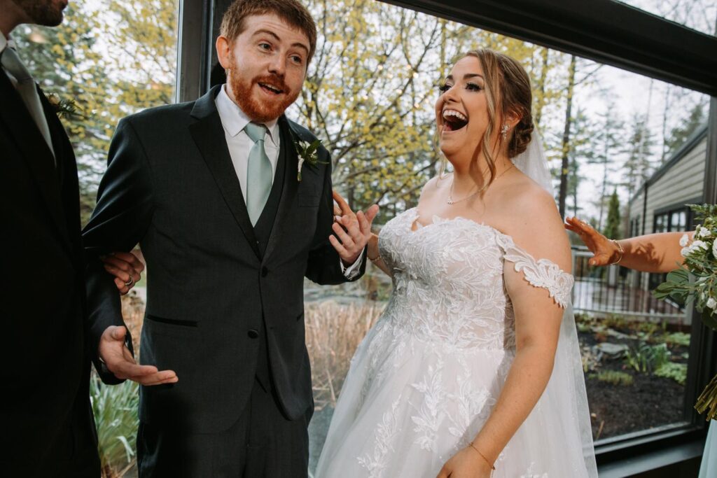 Bride and groom laughing together during a candid portrait session before the ceremony