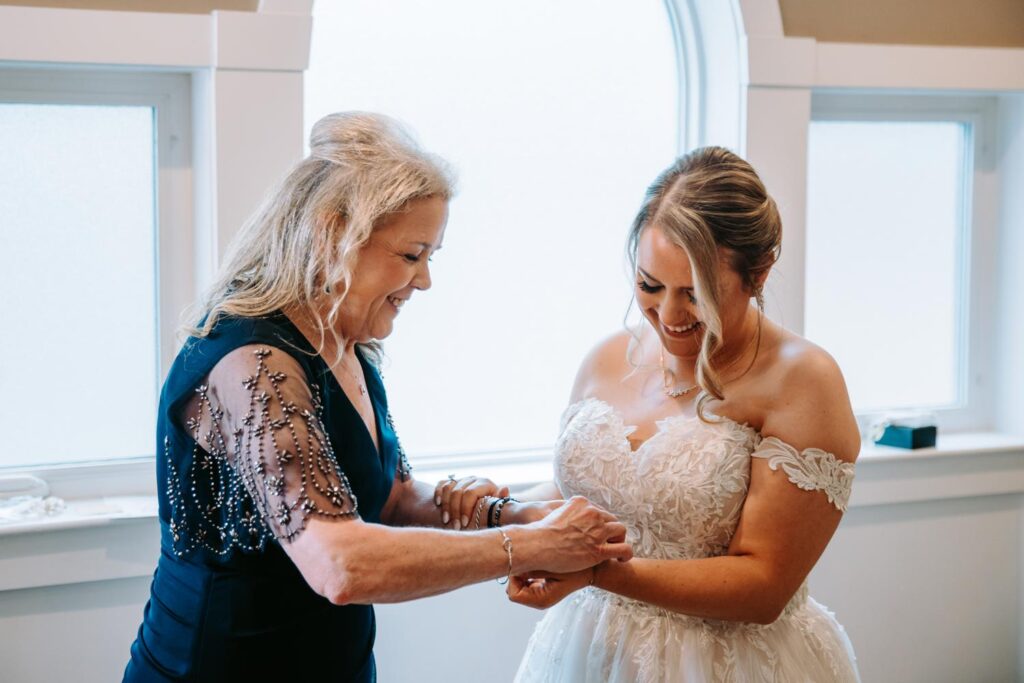 Bride sharing a sweet, emotional moment while getting ready with her mom at Birch Wood Vineyards