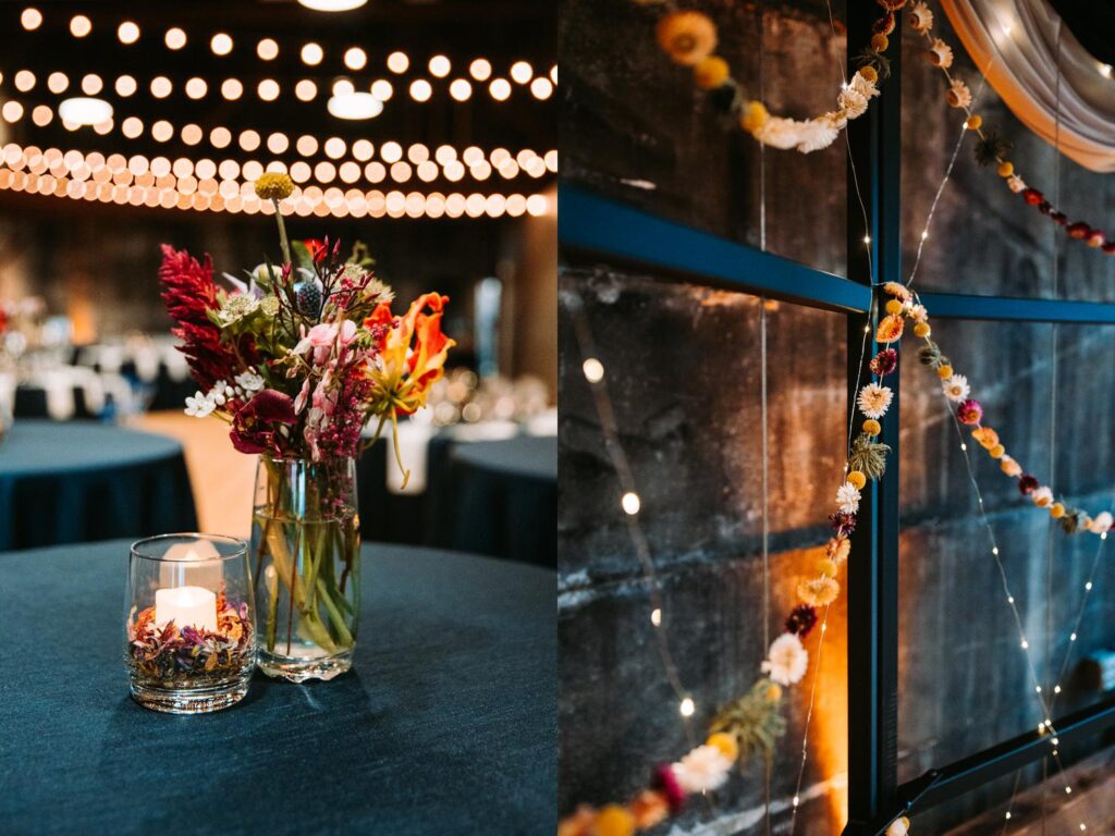 Moody detail shot of a vase filled with wild florals on a navy reception table.