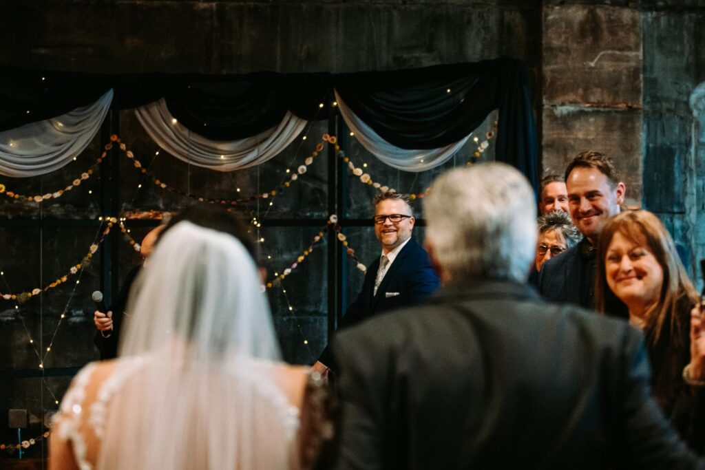 Groom looking emotional as he watches Dayna walk down the aisle.