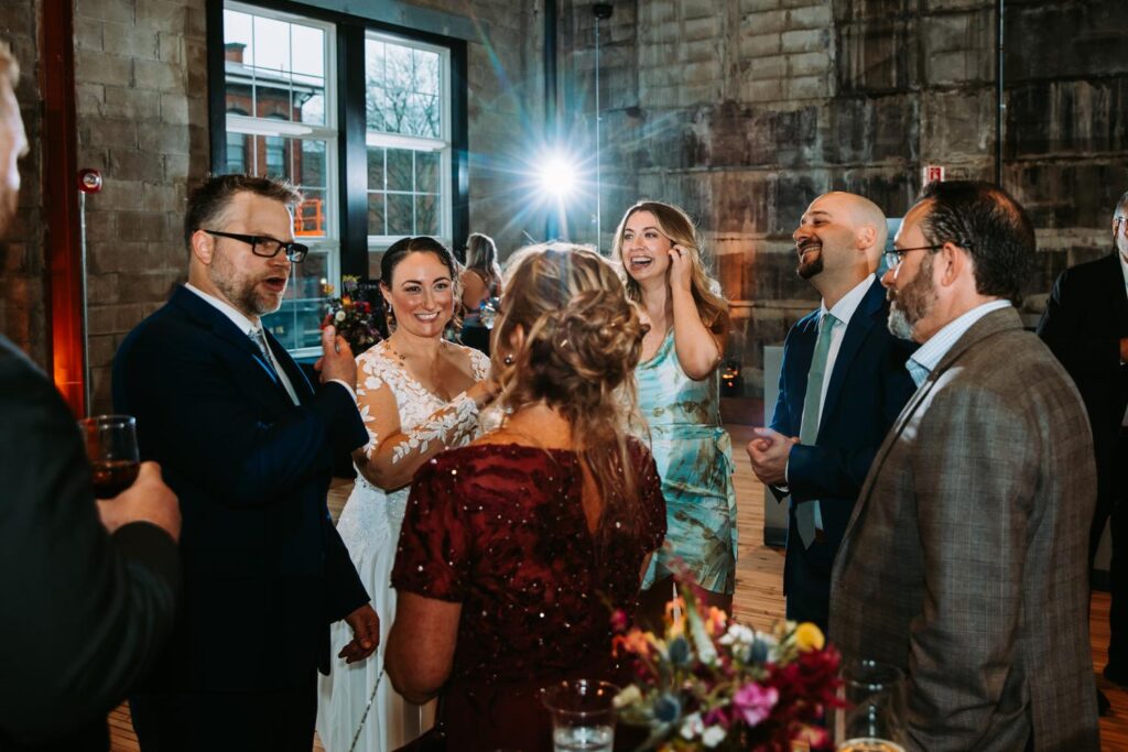 Guests cheering and congratulating the newlyweds during the reception.