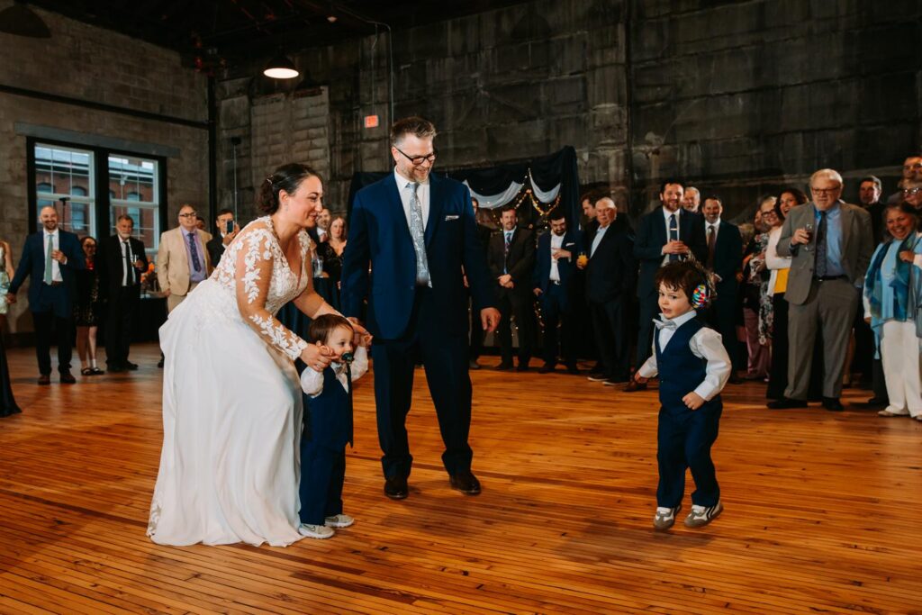 Dayna and Aaron dancing with their toddlers during a sweet family-first dance.