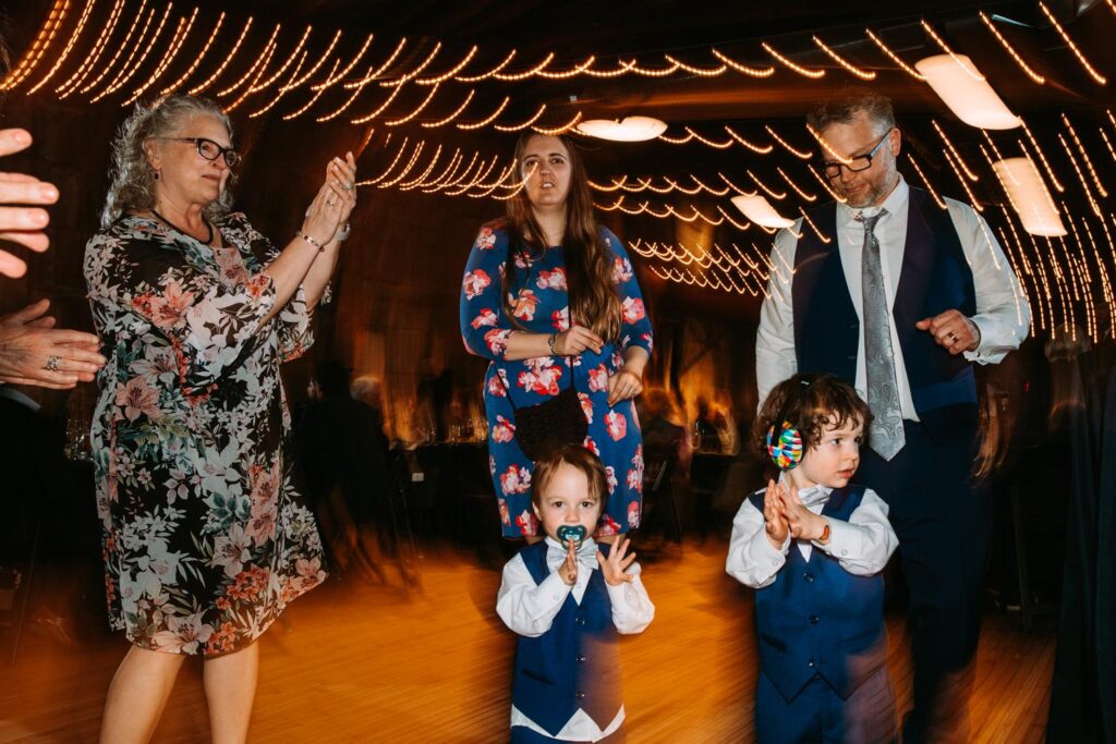 Kids dancing with adults under the string lights at the Olio dance floor.