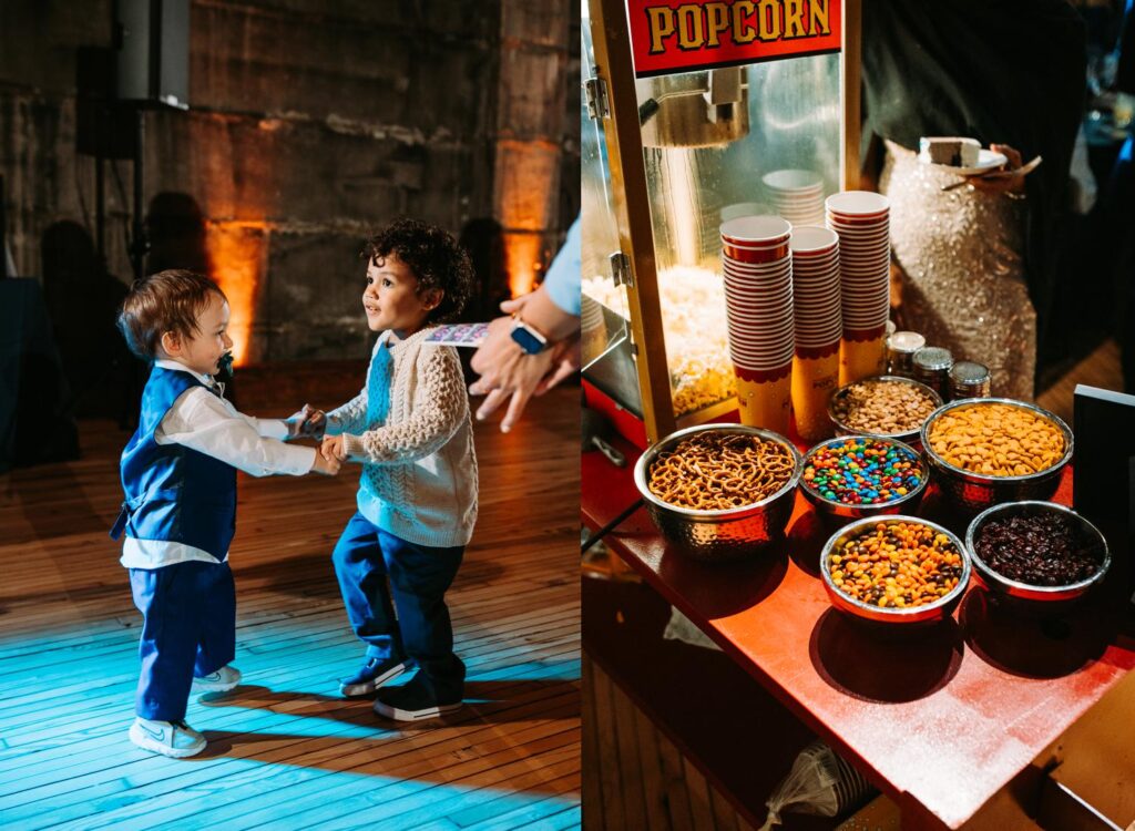 Young siblings dancing together near the popcorn snack station.