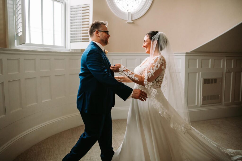 Bride and groom sharing an emotional first look in an upstairs room at The Bell Inn.