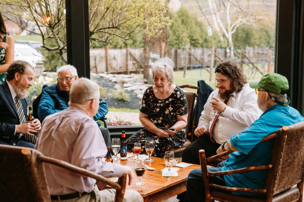 Guests enjoying cocktails and conversation at cozy indoor lounge seating area