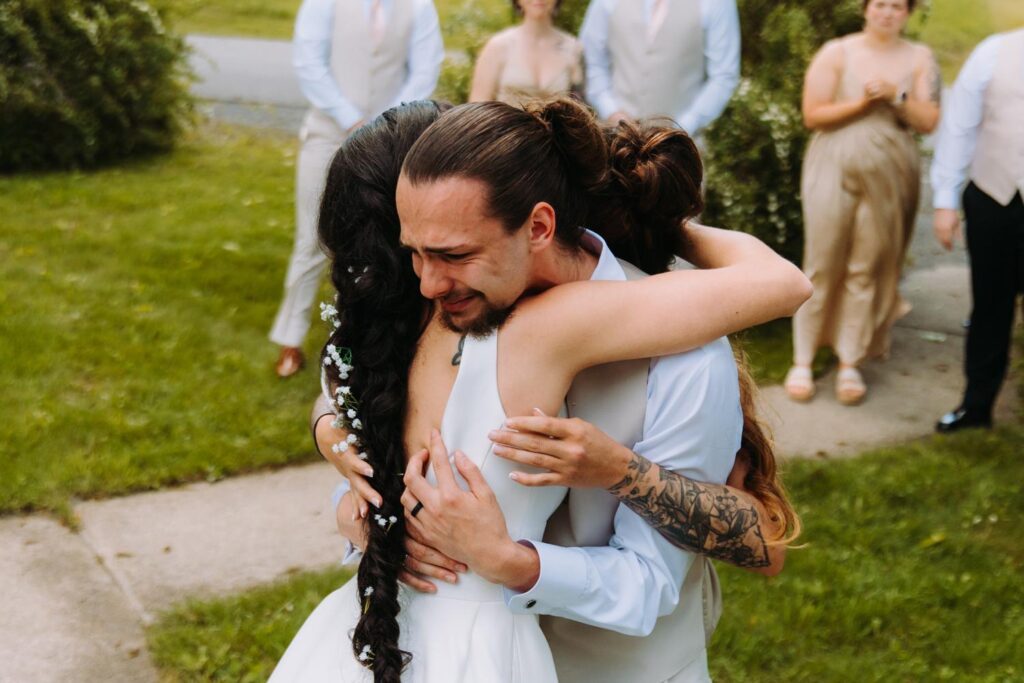  Bride hugging her brother during cocktail hour at this Catskills wedding.