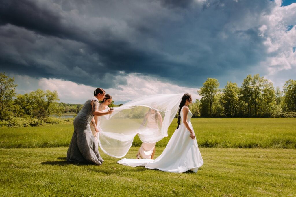 Bride's veil at Bluebird Farm under a dramatic stormy sky.