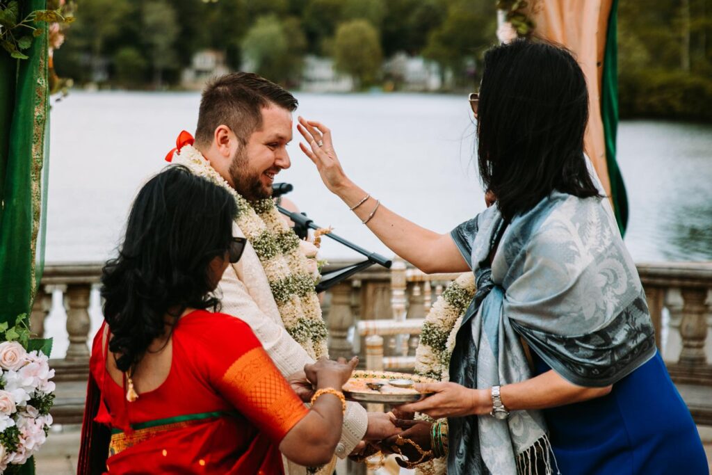 Bride and groom with family during ritual of Indian wedding ceremony at Grandview Mendon Massachusetts