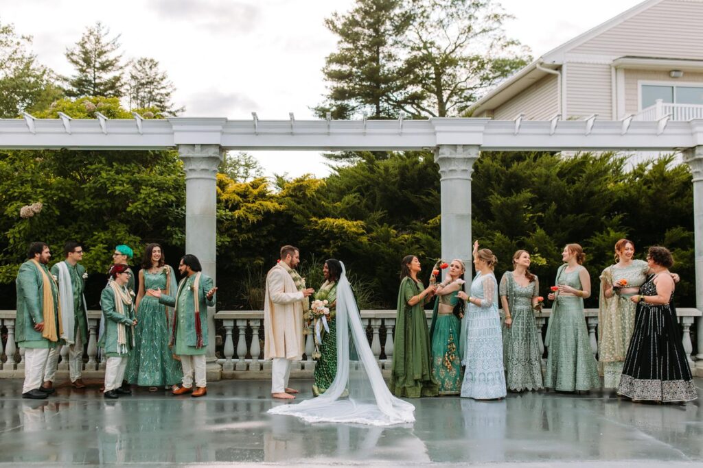 Wedding party laughing together in vibrant attire at Grandview Mendon Massachusetts Indian wedding