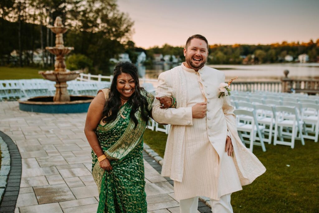 Bride laughing in groom’s arms during Indian wedding portraits at Grandview Mendon Massachusetts