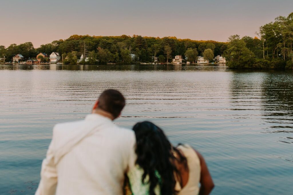 Bride and groom standing near fountain during Indian wedding portraits at Grandview Mendon Massachusetts