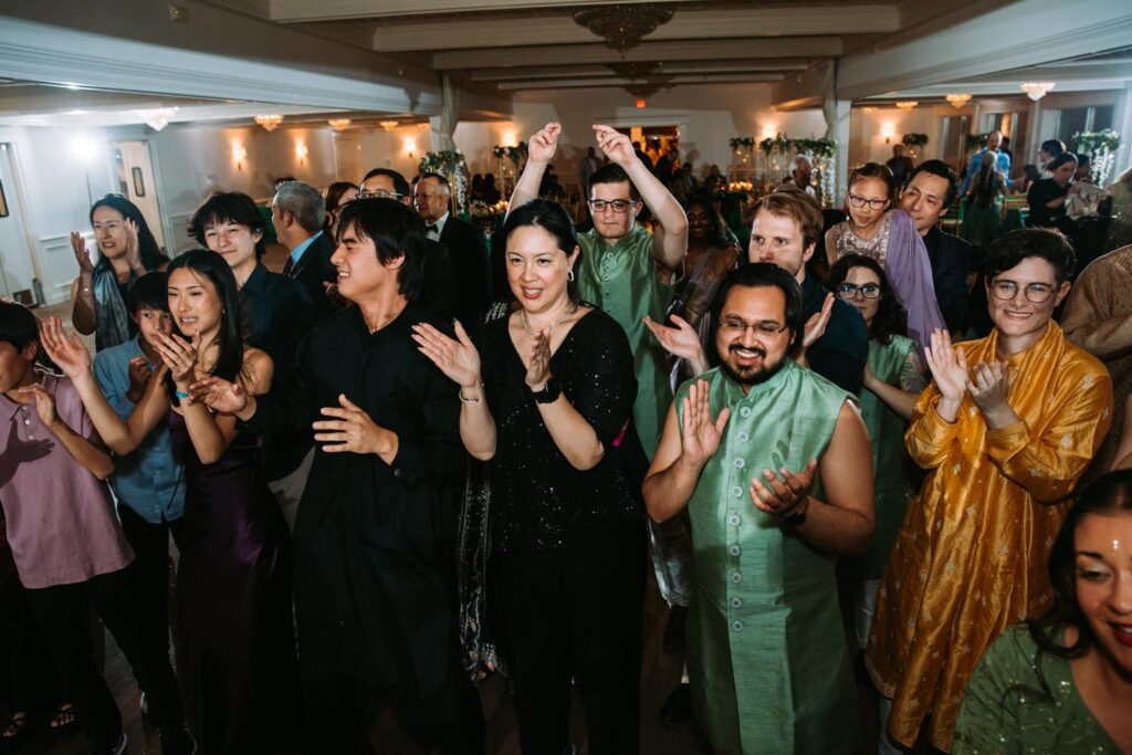 Guests mid-dance with hands raised at Grandview Mendon Massachusetts Indian wedding reception