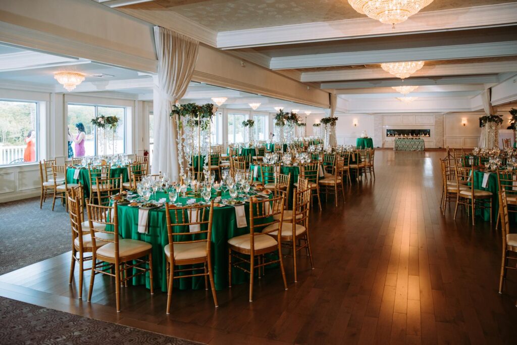 Wedding reception tables decorated with greenery and candles inside Grandview Mendon Massachusetts venue