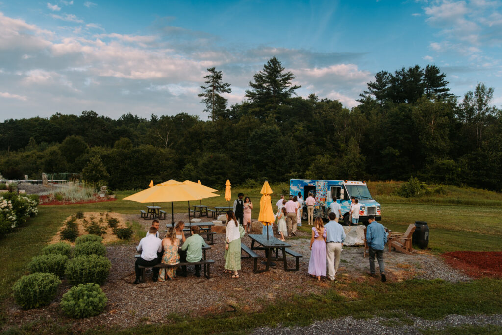 Guests gather on the lawn at Greenhouse on the River in New Hampshire