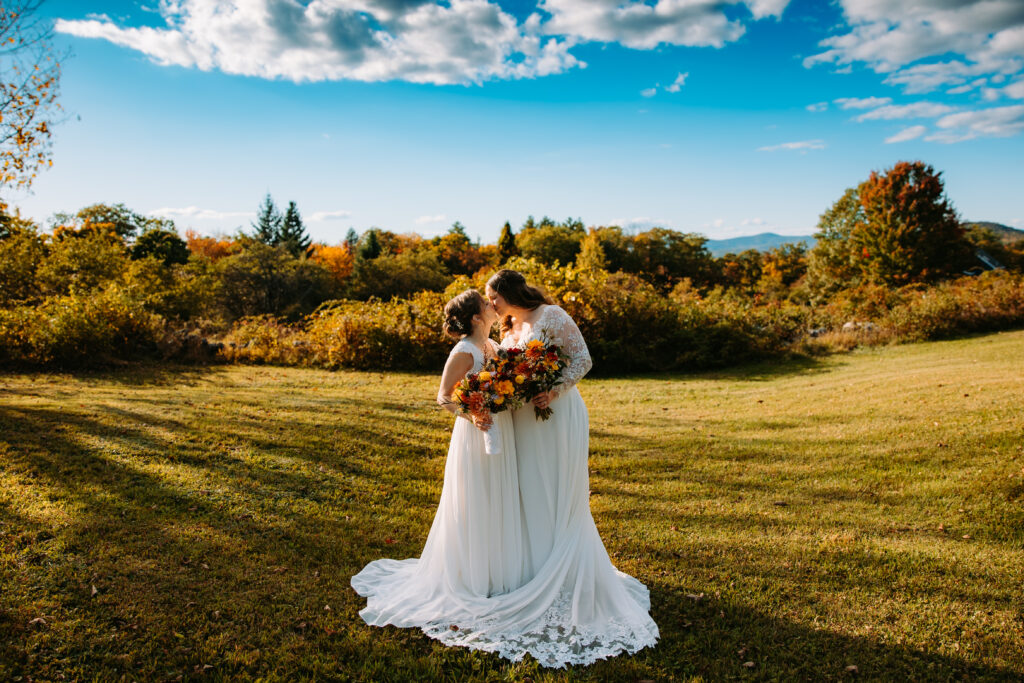 Two brides share a kiss at Maple Rock Farm in Parsonsfield, Maine on their wedding day