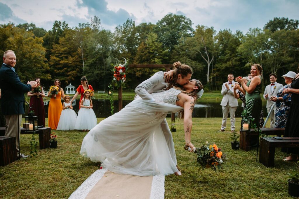 A bride and groom kiss at their backyard wedding ceremony in Moodus, Connecticut