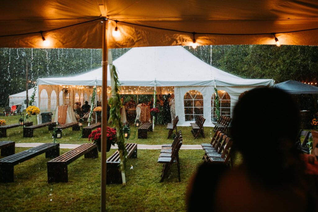 A rainy scene during a backyard wedding in Moodus, Connecticut captured by a Connecticut wedding photographer