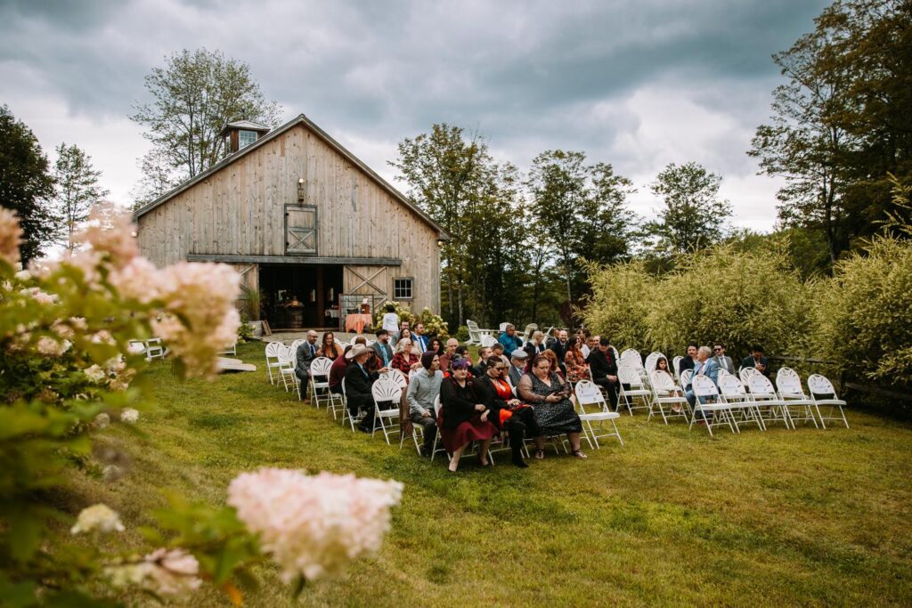 Guests gathering for outdoor ceremony at The Barn on Gobeille Farm in Sharon Vermont