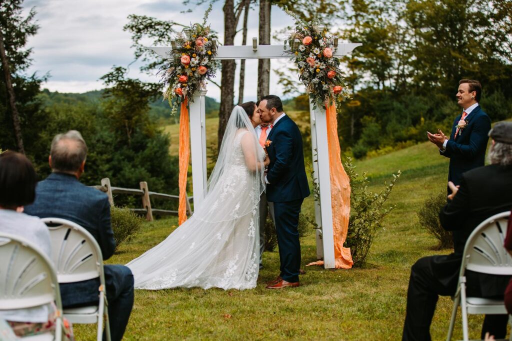 First kiss as newlyweds at The Barn on Gobeille Farm outdoor ceremony in Sharon Vermont