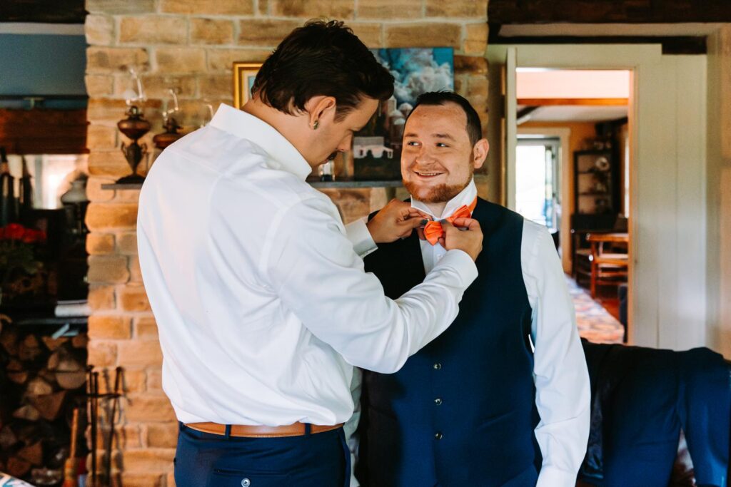 Groom getting ready in cottage at The Barn on Gobeille Farm wedding in Sharon Vermont