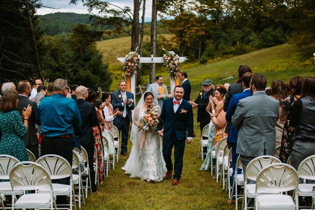 Guests cheering for Laura and AJ after ceremony at The Barn on Gobeille Farm in Vermont