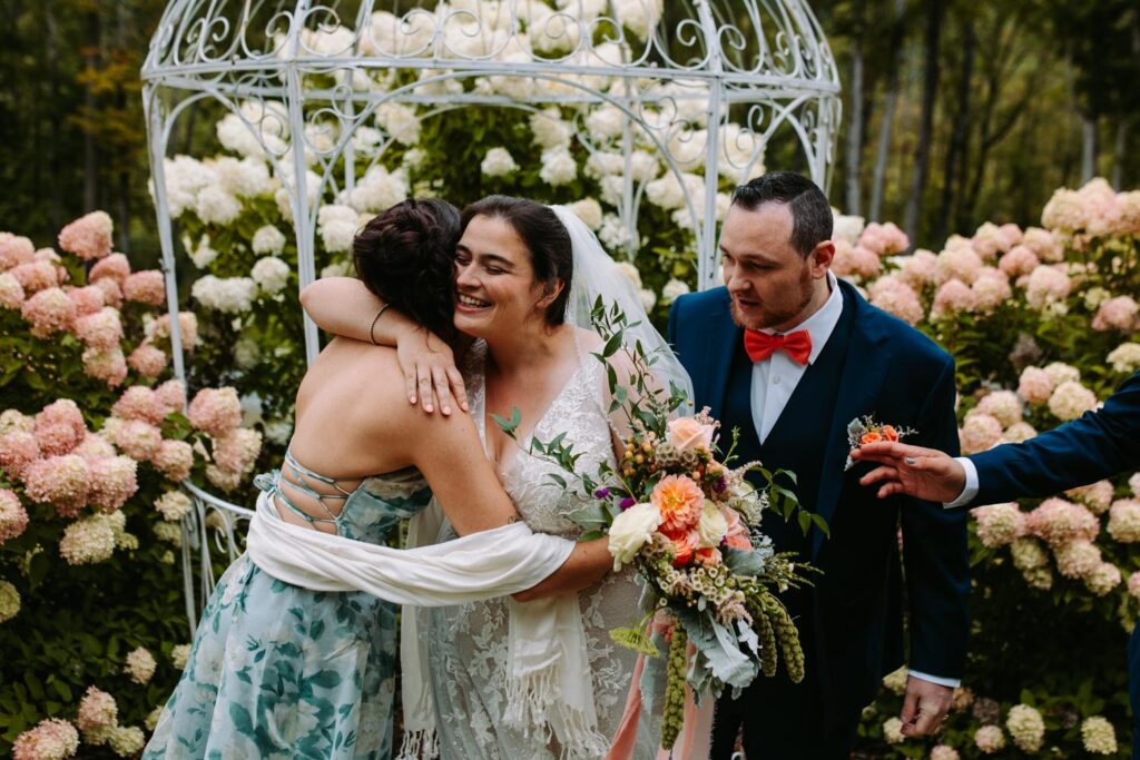 Laura and AJ laughing during portraits at The Barn on Gobeille Farm wedding in Sharon Vermont