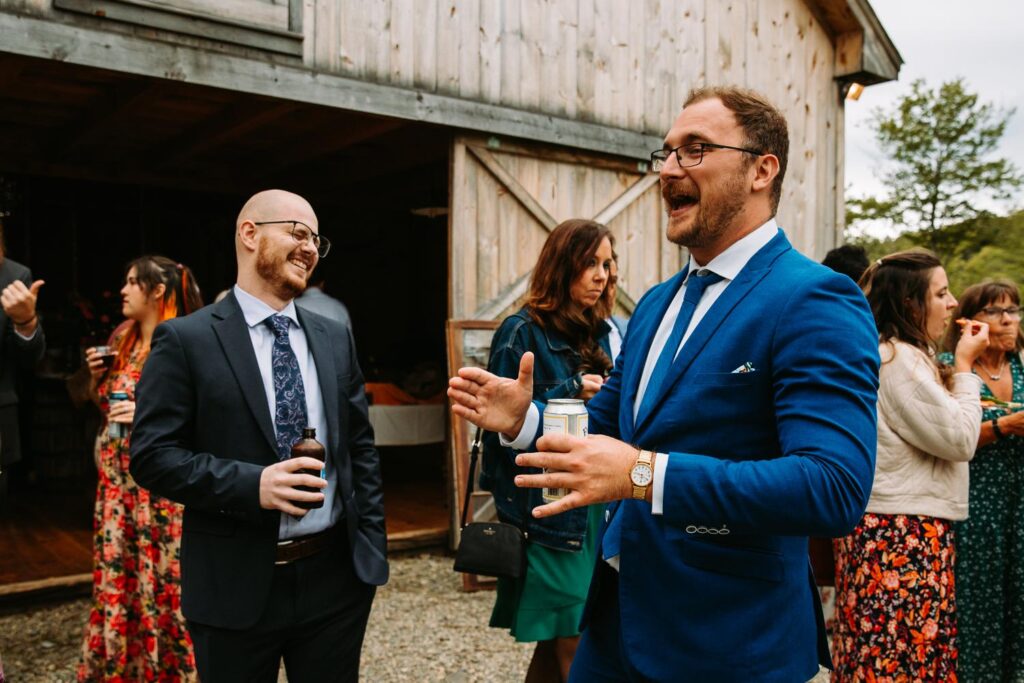 Guests enjoying cocktail hour at The Barn on Gobeille Farm wedding in Sharon Vermont