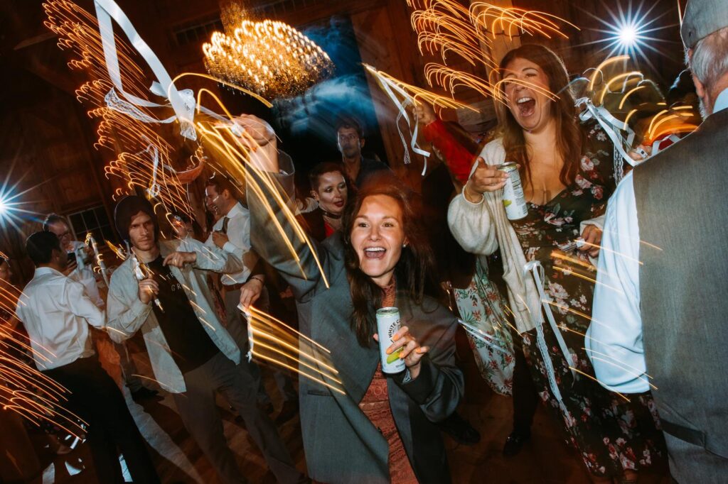 Guests dancing at The Barn on Gobeille Farm wedding reception in Sharon Vermont