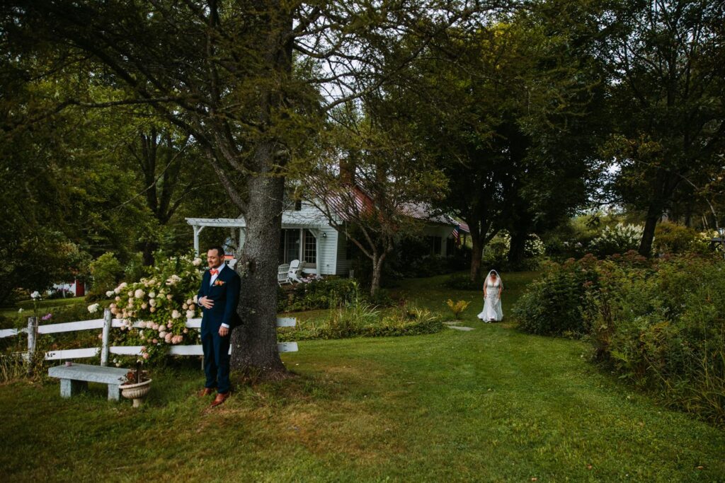 Laura and AJ first touch moment before ceremony at The Barn on Gobeille Farm in Sharon Vermont