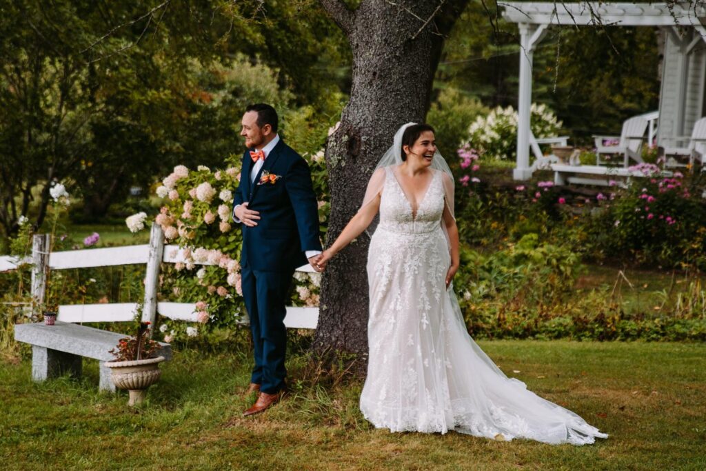 Bride and groom holding hands before ceremony at The Barn on Gobeille Farm in Sharon Vermont
