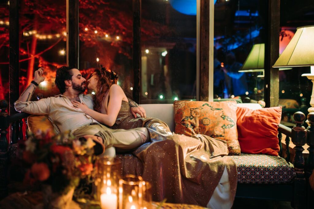 A bride and groom share an intimate moment on a couch at their campground wedding reception in the Berkshires