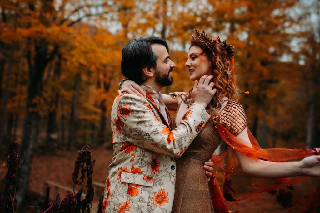 A couple poses together dressed in fantasy-themed attire for their wedding at Race Brook Lodge