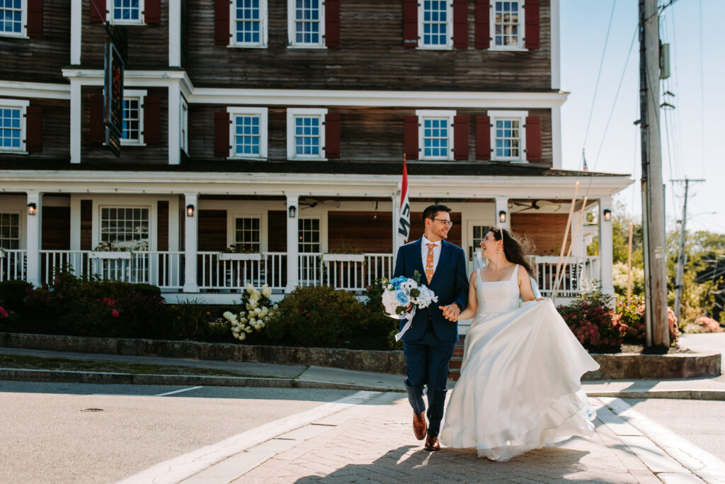 A bride and groom cross the street at their wedding at Red Lion Inn