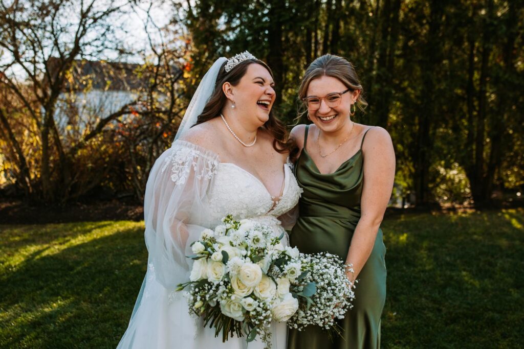 Marlee and bridesmaid laughing during portraits at The Publick House wedding in Sturbridge Massachusetts