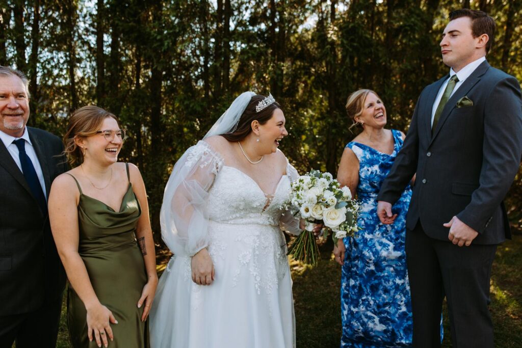 Marlee laughing with family during portraits at The Publick House wedding in Sturbridge Massachusetts