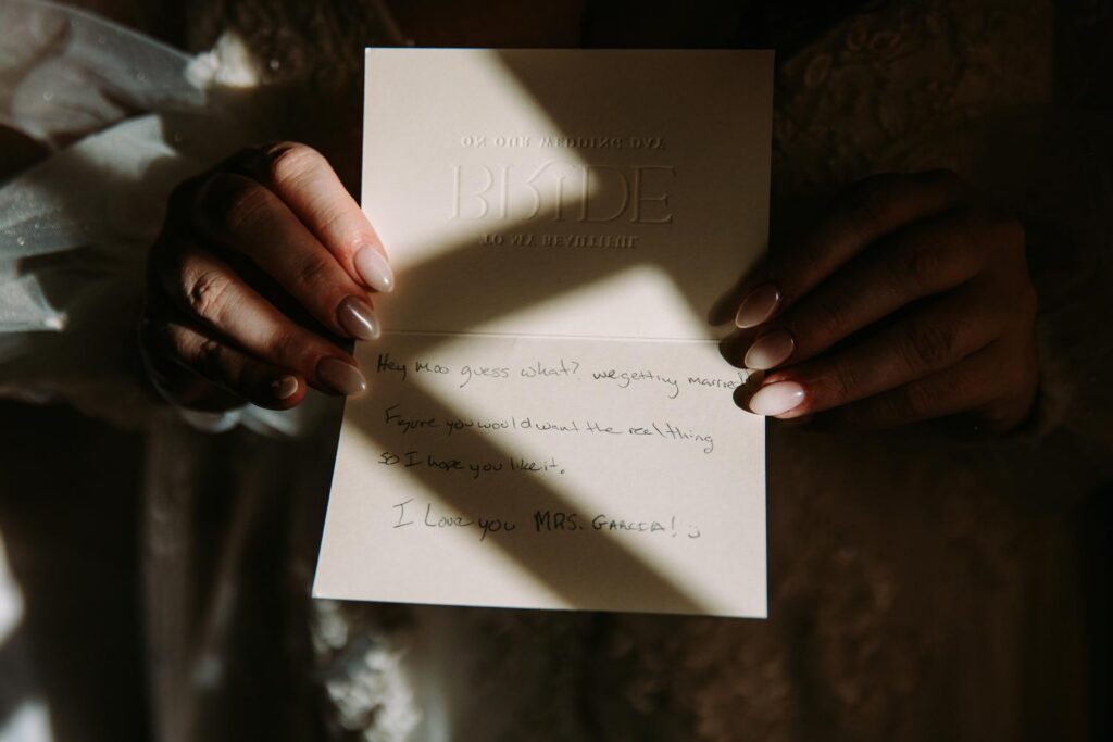 Marlee reading note from Dominic  while getting ready at The Publick House wedding in Sturbridge Massachusetts