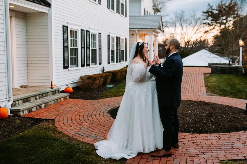 Bride and groom sharing a quiet moment together outside the white colonial-style buildings