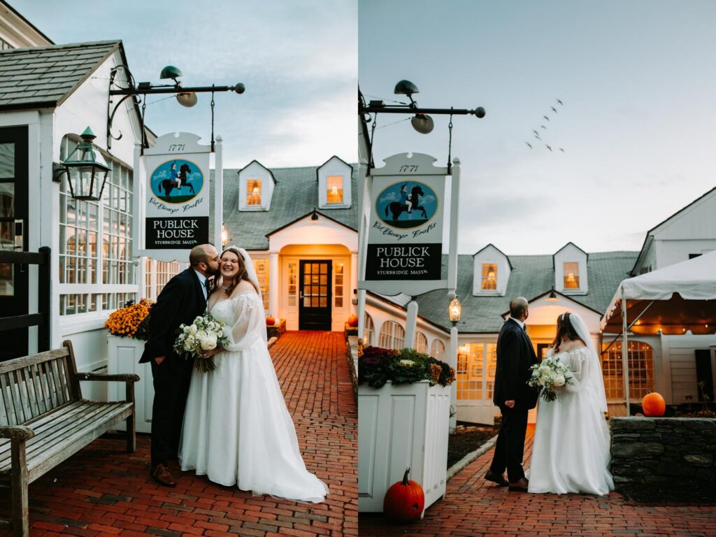 Couple sharing a kiss in front of a warmly lit historic building at dusk