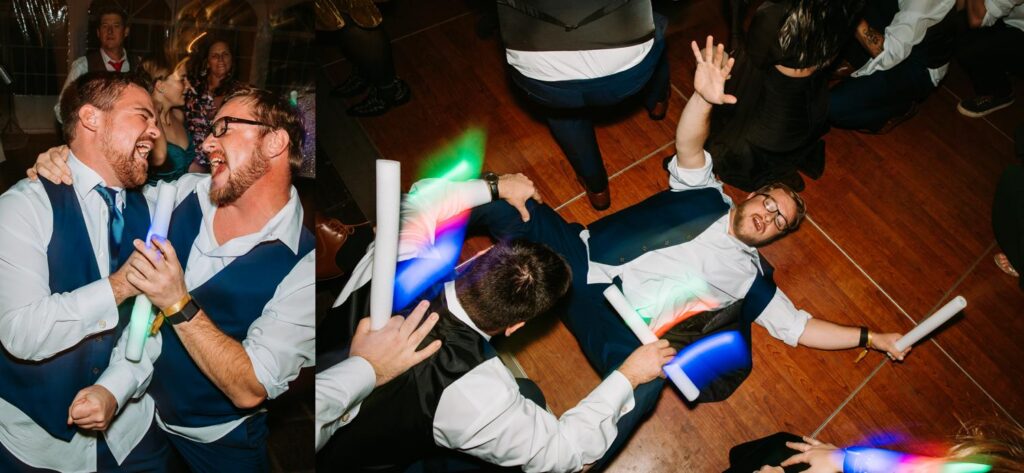 Groomsman lying on the dance floor while others dance and celebrate around him