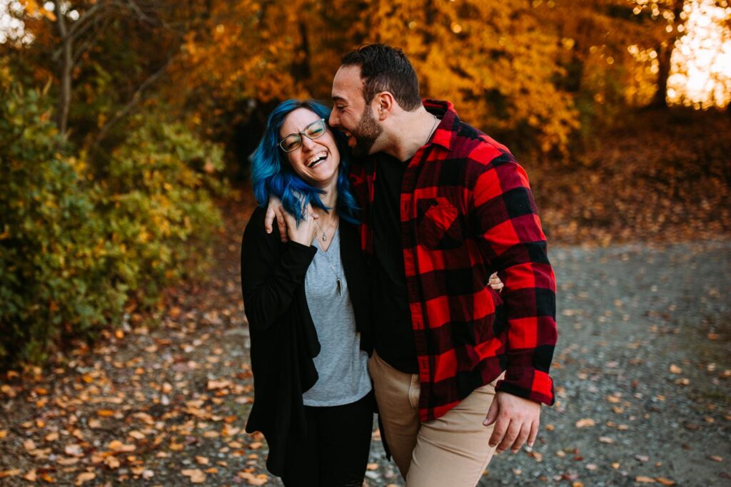 Couple laughs together at their engagement session at Lincoln Woods State Park