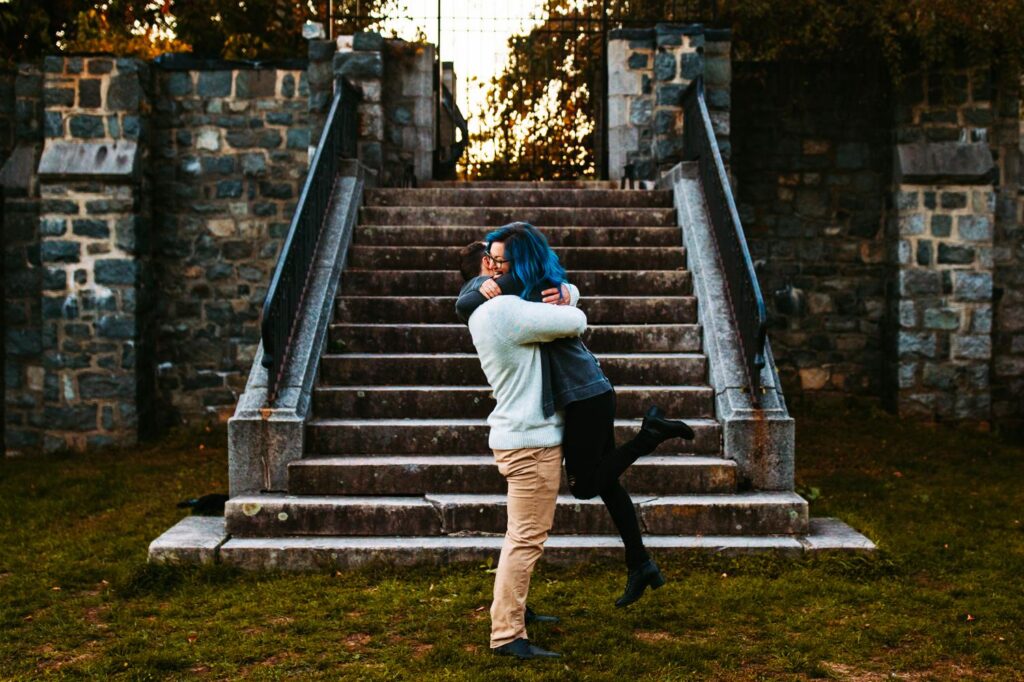 Man picks up fiance during engagement photos at Cumberland Library in Rhode Island